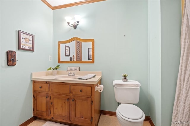 bathroom with baseboards, vanity, and toilet