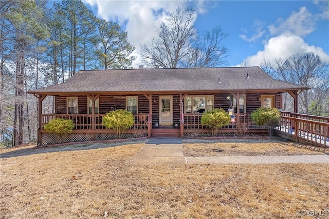 view of front of house featuring covered porch and a shingled roof