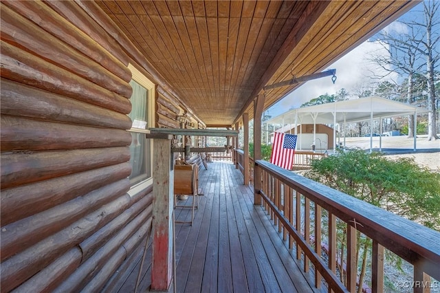 wooden deck featuring an outdoor structure and a storage shed