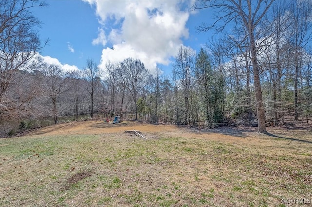 view of yard featuring a forest view