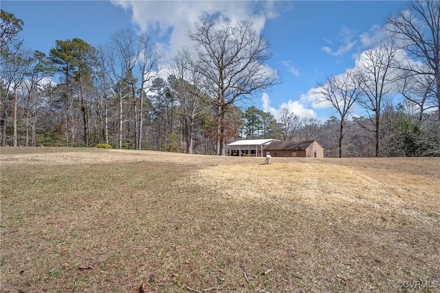 view of yard with a view of trees