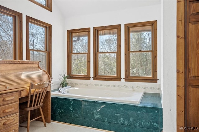 full bathroom featuring vaulted ceiling and a bath