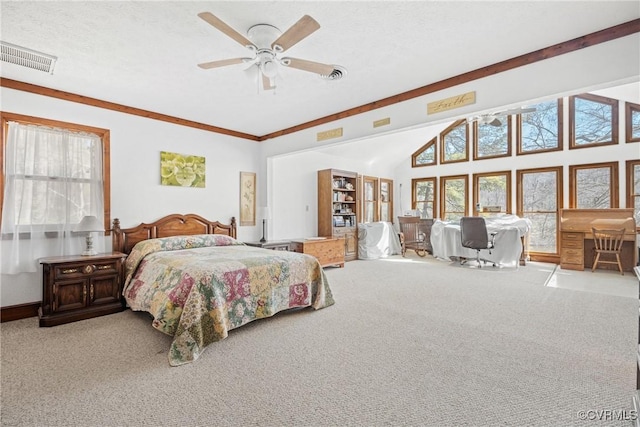 carpeted bedroom featuring lofted ceiling, ceiling fan, visible vents, and a textured ceiling