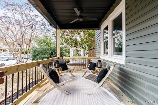 wooden terrace featuring a ceiling fan