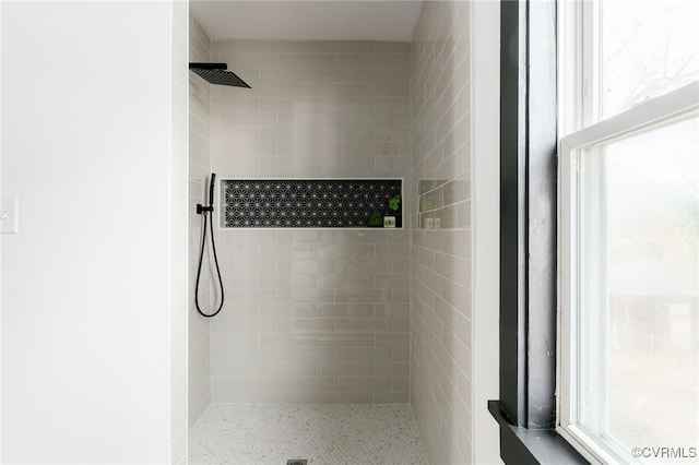 full bath with plenty of natural light and tiled shower