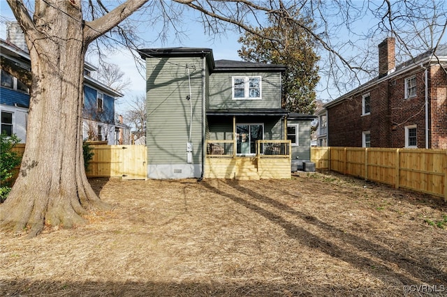 back of house with crawl space and fence