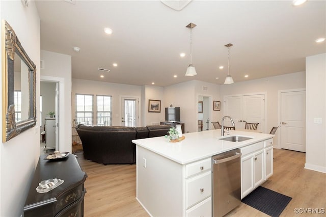 kitchen with dishwasher, light wood-style floors, a sink, and white cabinets