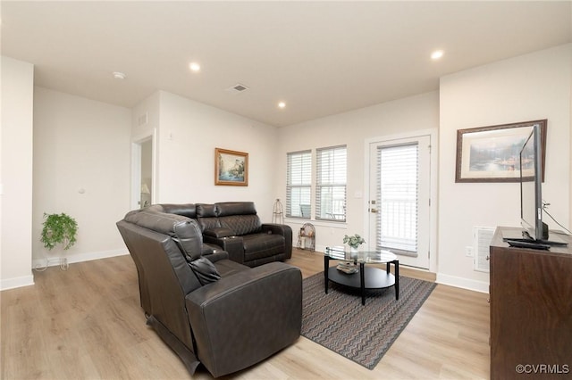 living room featuring recessed lighting, light wood-style flooring, and baseboards