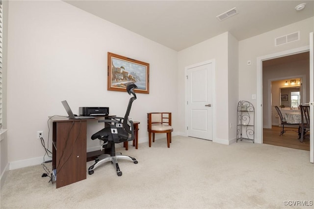 home office featuring carpet floors, visible vents, and baseboards