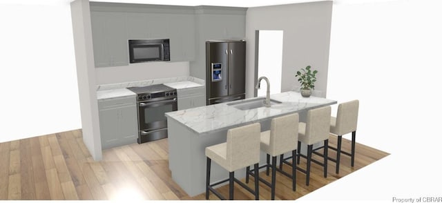 kitchen featuring electric range, a sink, a kitchen breakfast bar, light wood-style floors, and stainless steel refrigerator with ice dispenser