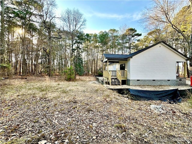 view of property exterior with crawl space