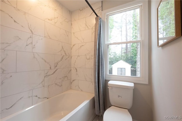 full bathroom featuring shower / tub combo and toilet