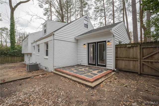 back of house featuring central air condition unit, crawl space, fence, and brick siding