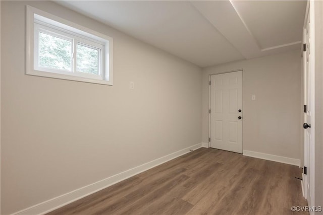 spare room featuring wood finished floors and baseboards