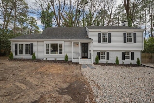 split level home with brick siding and a chimney