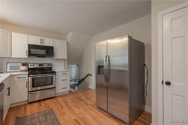 kitchen with decorative backsplash, stainless steel appliances, light countertops, light wood-type flooring, and white cabinetry