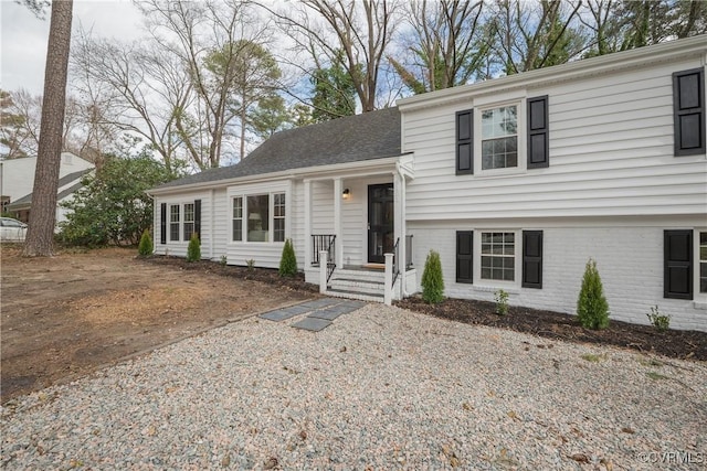 tri-level home featuring brick siding