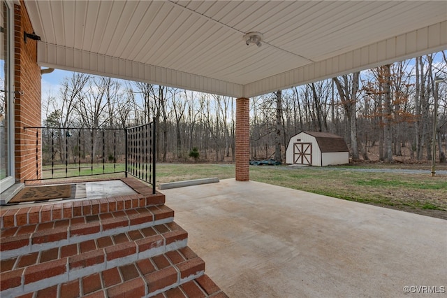 view of patio / terrace with an outdoor structure and a shed