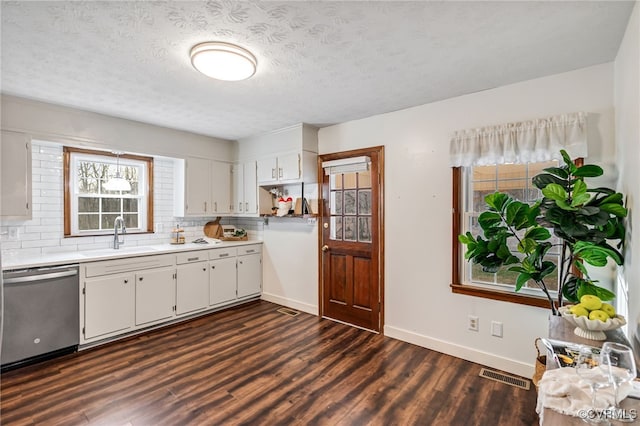 kitchen with dark wood-style flooring, light countertops, visible vents, a sink, and dishwasher