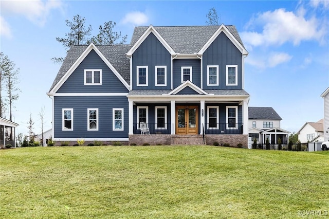 craftsman-style house featuring a front lawn, a porch, board and batten siding, and french doors