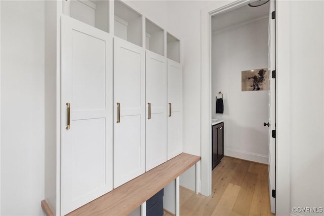 mudroom featuring light wood-style floors and baseboards