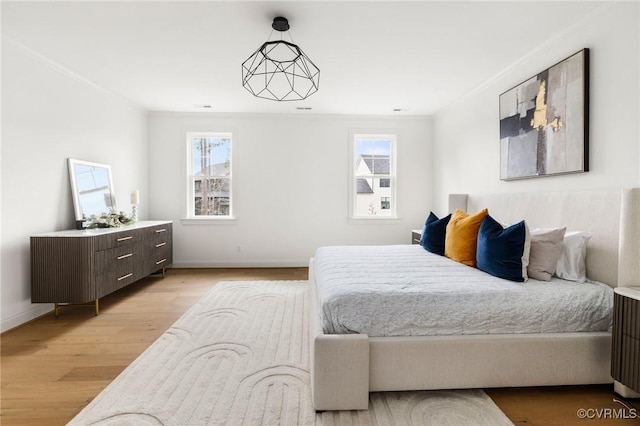 bedroom featuring light wood-type flooring and baseboards