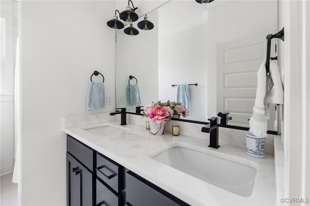 bathroom featuring a sink and double vanity