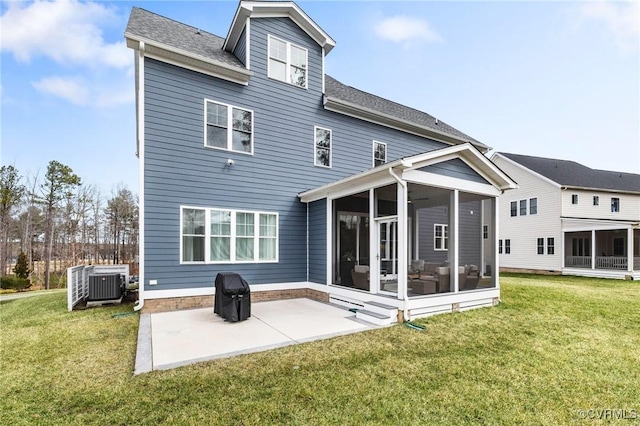 back of house with central air condition unit, a yard, a sunroom, and a patio