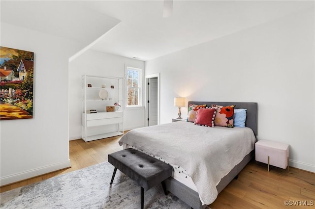 bedroom with light wood-type flooring and baseboards