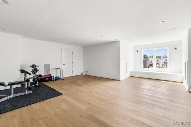 workout room with hardwood / wood-style floors, visible vents, and recessed lighting