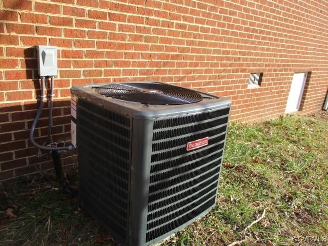 exterior details with central AC and brick siding