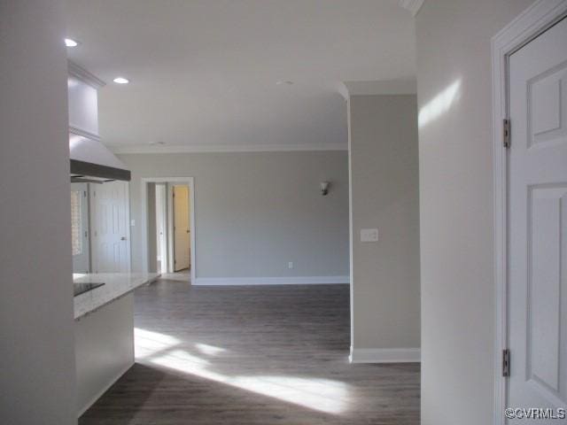 unfurnished room featuring ornamental molding, recessed lighting, wood finished floors, and baseboards