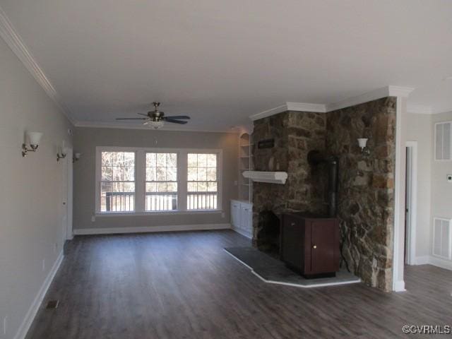 unfurnished living room featuring dark wood-style floors, visible vents, ornamental molding, and baseboards