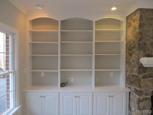 interior details with built in features and crown molding