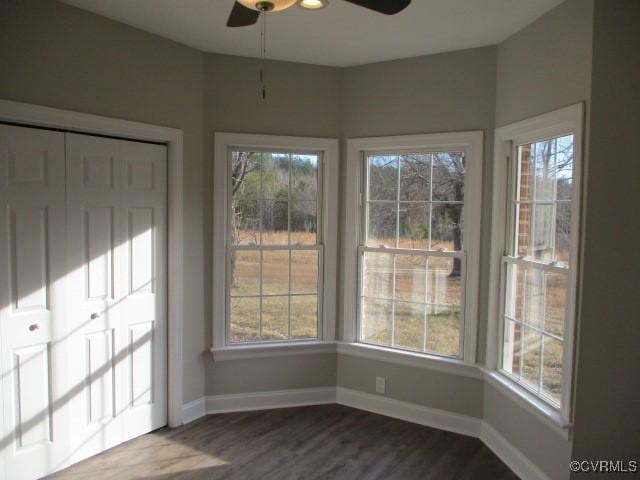 unfurnished sunroom with a ceiling fan