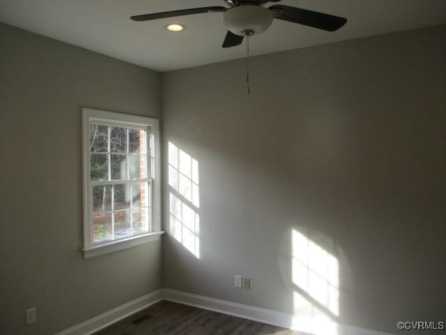 empty room with a ceiling fan, baseboards, dark wood-style flooring, and recessed lighting