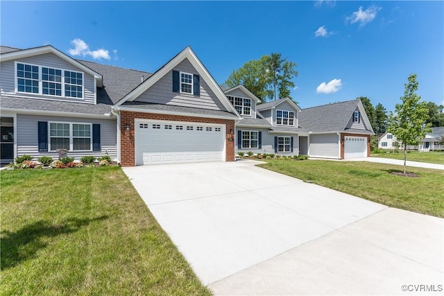 view of front of home with a garage, concrete driveway, brick siding, and a front yard