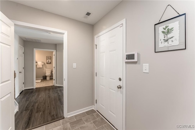 entrance foyer with visible vents, baseboards, and wood finished floors