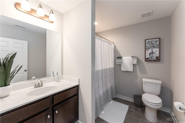 full bathroom featuring toilet, vanity, visible vents, and baseboards