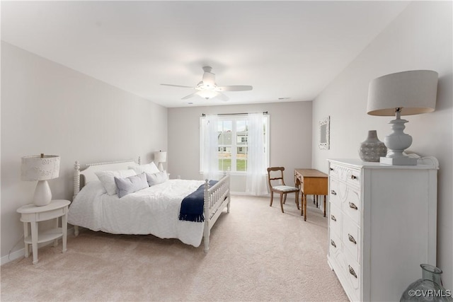 bedroom featuring light colored carpet, ceiling fan, and baseboards