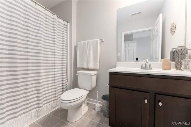 full bathroom with toilet, vanity, baseboards, visible vents, and tile patterned floors