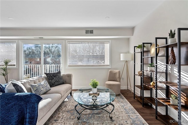 living room with visible vents, dark wood finished floors, and baseboards