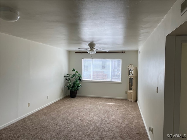 unfurnished room featuring ceiling fan, carpet flooring, visible vents, and baseboards