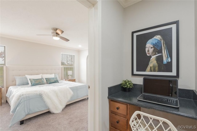 carpeted bedroom featuring ceiling fan and ornamental molding