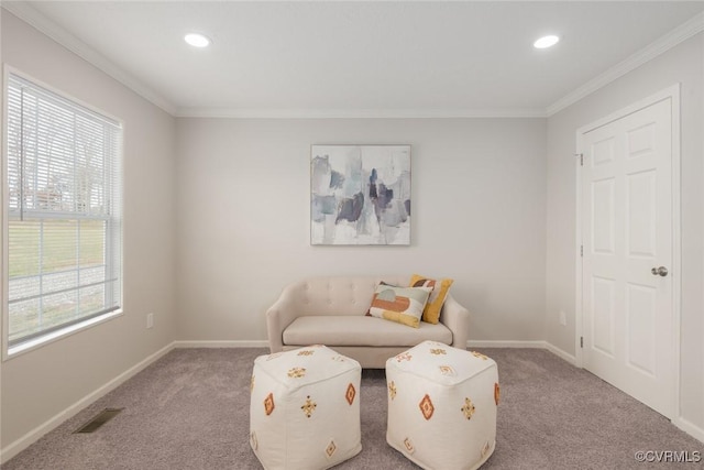 living area featuring baseboards, carpet floors, visible vents, and crown molding