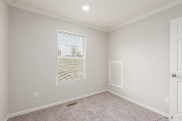 unfurnished room featuring ornamental molding, carpet flooring, visible vents, and baseboards