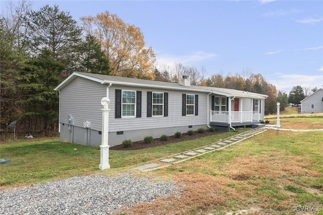 manufactured / mobile home with a front yard, crawl space, and a chimney