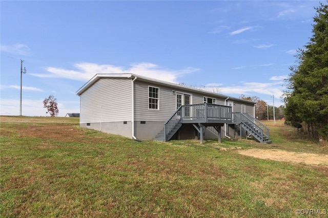 back of house featuring a yard, stairway, crawl space, and a wooden deck