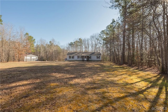 view of yard with a wooded view