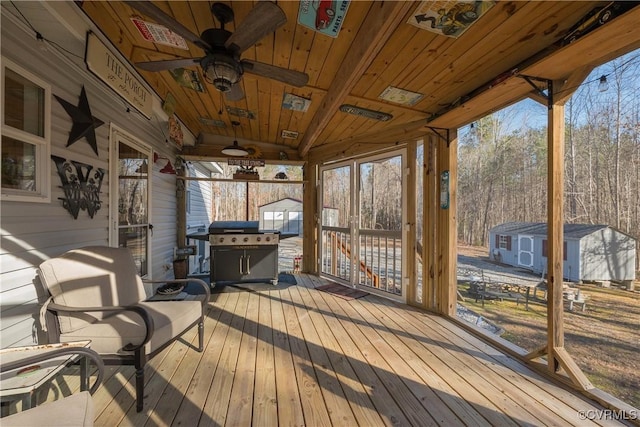 sunroom / solarium with wood ceiling and a ceiling fan